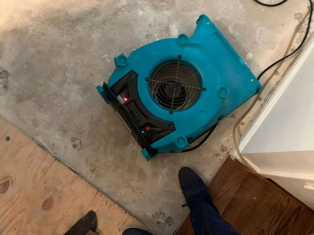 Air mover drying subfloor during Leak Detection & Repair in Platteville
